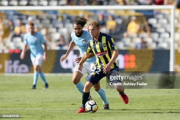 Jacob Melling of the Mariners is contested by Osama Malik of Melbourne City during the round 16 A-League match between the Central Coast Mariners and...