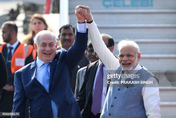 Indian Prime Minister Narendra Modi and Israeli Prime Minister Benjamin Netanyahu pose for photographers after NEtanyahu arrived at the Air Force...