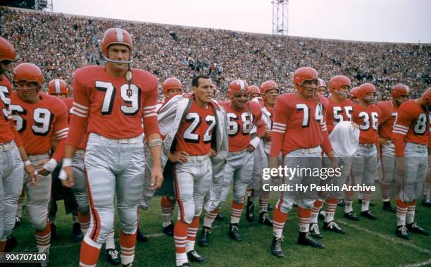 Bob St. Clair, Joe Arenas and Bob Toneff of the San Francisco 49ers stand on the sideline during an NFL game against the Cleveland Browns on August...