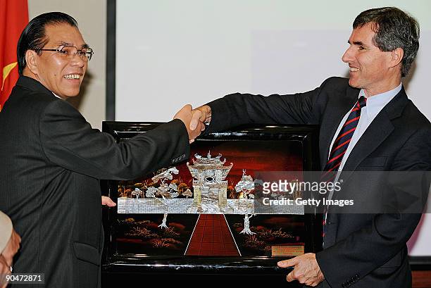 General Secretary of the Central Committee of the Communist Party of Vietnam Mr Nong Duc Manh presents a gift to Hoc Mai Foundation Chairperson Bruce...