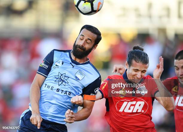 Alex Brosque of Sydney FC heads for goal over Michael Marrone of Adelaide United during the round 16 A-League match between Adelaide United and...