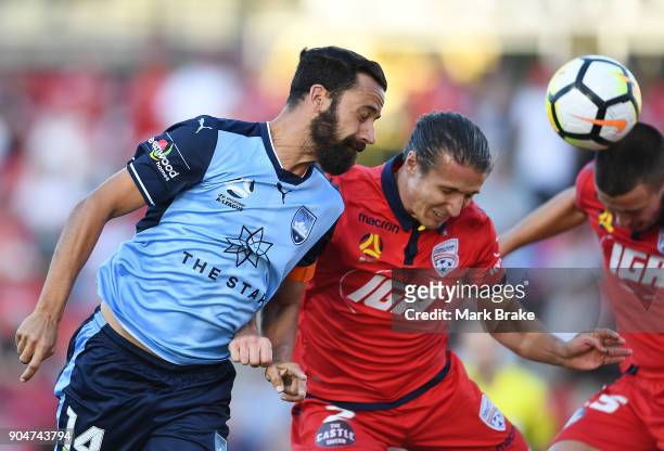 Alex Brosque of Sydney FC heads for goal over Michael Marrone of Adelaide United during the round 16 A-League match between Adelaide United and...