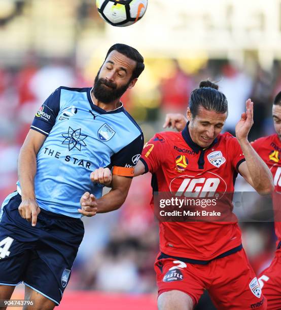 Alex Brosque of Sydney FC heads for goal over Michael Marrone of Adelaide United during the round 16 A-League match between Adelaide United and...