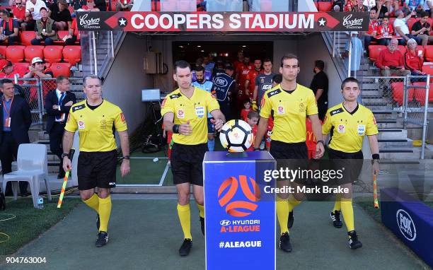 Referees take the ball at the start of the round 16 A-League match between Adelaide United and Sydney FC at Coopers Stadium on January 14, 2018 in...