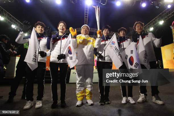 Torch bearer holds the PyeongChang 2018 Winter Olympics torch during the PyeongChang 2018 Winter Olympic Games torch relay on January 14, 2018 in...