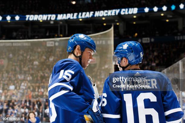 Matt Martin of the Toronto Maple Leafs and Mitchell Marner talk during a time out at an NHL game against the Ottawa Senators during the second period...