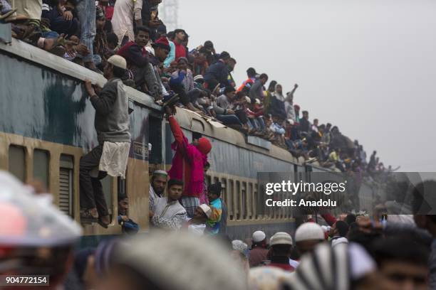 Bangladeshi Muslim devotees climb on a train to take part in Akheri Munajat, the final prayers at the World Muslim Congregation Biswa Ijtema, at...