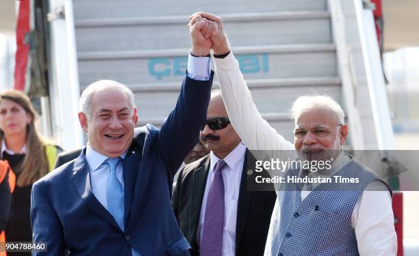 Prime Minister Narendra Modi welcomes Israeli Prime Minister Benjamin Netanyahu on their arrival at the Air Force Palam airport Station on January...