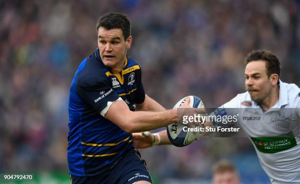 Leinster player Jonathan Sexton breaks away from Ruaridh Jackson of Glasgow during the European Rugby Champions Cup match between Leinster Rugby and...
