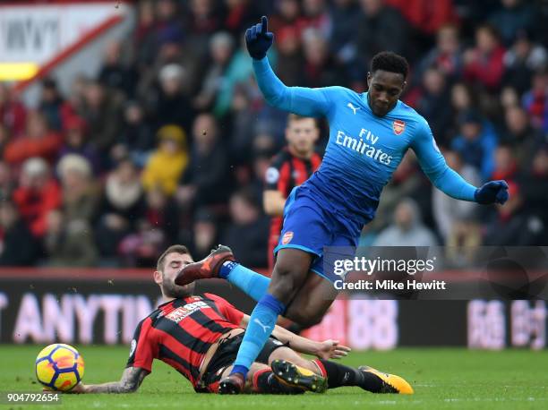 Steve Cook of AFC Bournemouth tackles Danny Welbeck of Arsenal during the Premier League match between AFC Bournemouth and Arsenal at Vitality...