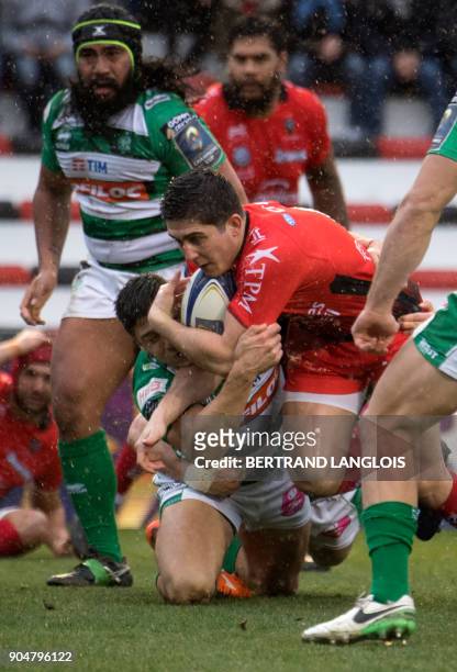 Toulon's French flyhalf Anthony Belleau is tackled during the Champions Cup rugby union match RC Toulon vs Benetton Rugby Treviso on January 14, 2018...