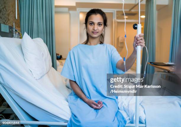 portrait of young patient holding iv drip in ward - hospital bed with iv stock pictures, royalty-free photos & images