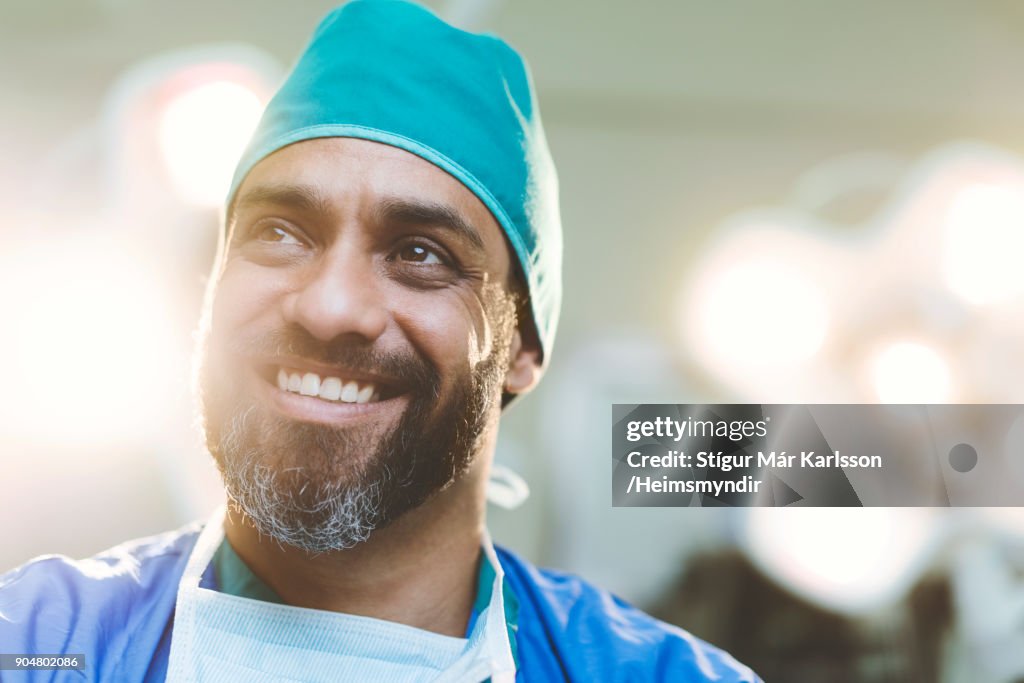 Thoughtful smiling doctor in hospital