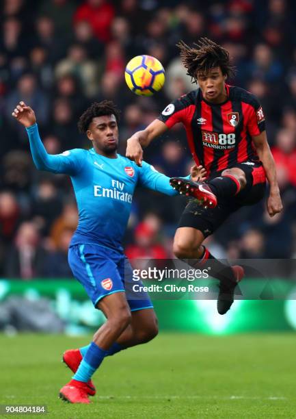 Alex Iwobi of Arsenal and Nathan Ake of AFC Bournemouth battles for possesion in the air during the Premier League match between AFC Bournemouth and...