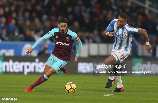 West Ham United's Manuel Lanzini and Huddersfield Town's Mathias Zanka Jorgensen during the Premier League match between Huddersfield Town and West...