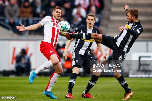 Simon Terodde of Koeln is challenged by Christoph Kramer of Moenchengladbach during the Bundesliga match between 1. FC Koeln and Borussia...