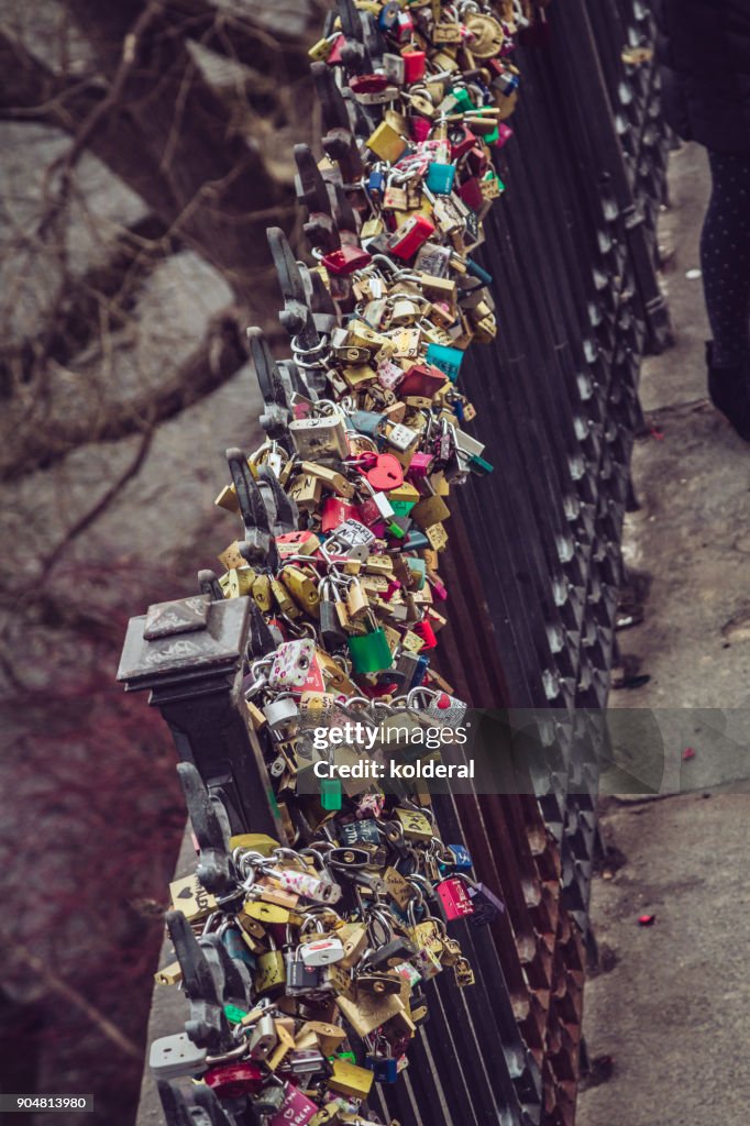 Love lockers on the iron fence on the bank of Vltava river in Prague