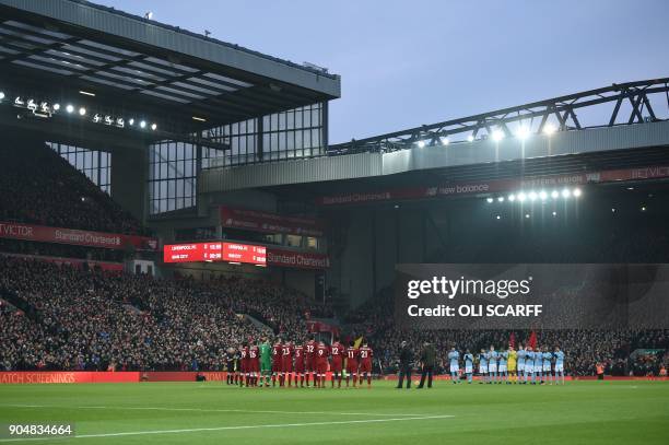 The teams take part in a minute's applause in honour of former Liverpool goalkeeper Tommy Lawrence who died on January 10 ahead of the kick off of...
