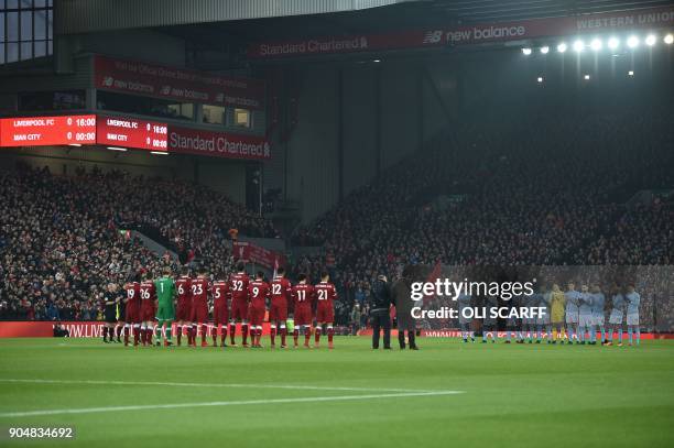 The teams take part in a minute's applause in honour of former Liverpool goalkeeper Tommy Lawrence who died on January 10 ahead of the kick off of...