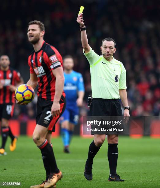 Simon Francis of Bournemouth is booked by Referee Kevin Friend during the Premier League match between AFC Bournemouth and Arsenal at Vitality...