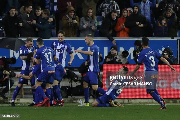 Deportivo Alaves' players celebrate after scoring a goal during the Spanish league football match between Alaves and Sevilla at the Mendizorrotza...