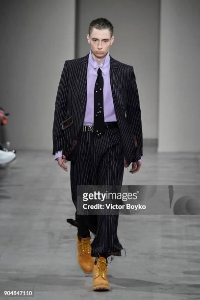 Model walks the runway at the Sulvam show during Milan Men's Fashion Week Fall/Winter 2018/19 on January 14, 2018 in Milan, Italy.