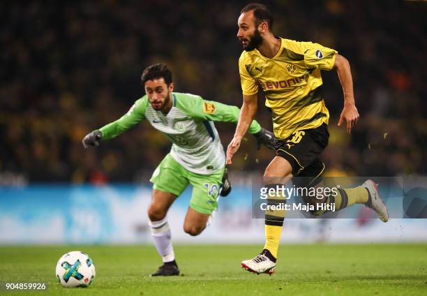 Omer Toprak of Borussia Dortmund and Yunus Malli of VfL Wolfsburg battle for the ball during the Bundesliga match between Borussia Dortmund and VfL...