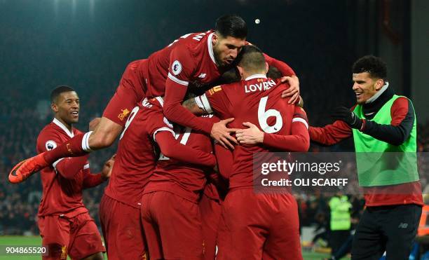 Liverpool's German midfielder Emre Can jumps into the celebration for the third Liverpool goal scored by Liverpool's Senegalese midfielder Sadio Mane...