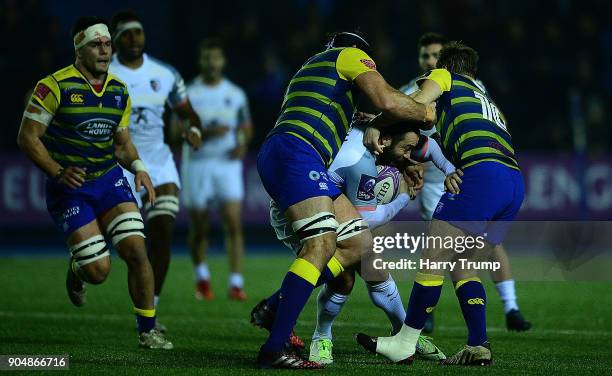 Jean-Marc Doussain of Toulouse is tackled by George Earle and Jarrod Evans of Cardiff Blues during the European Rugby Challenge Cup match between...