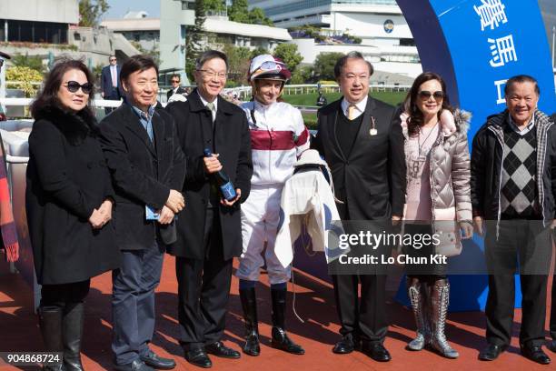 Jockey Douglas Whyte and owners celebrate after Hair Trigger wins Race 3 Oak Steamship Handicap at Sha Tin racecourse on January 13, 2018 in Hong...