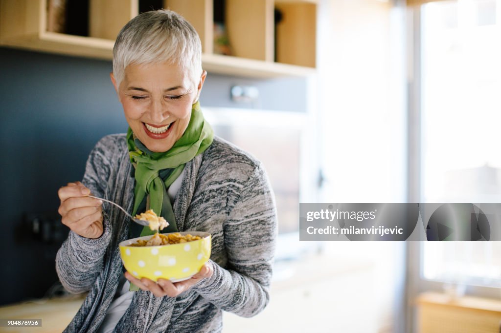 Mature woman having healthy breakfast