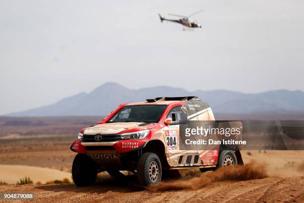 Giniel De Villiers of South Africa and Toyota Gazoo Racing drives with co-driver Dirk Von Zitzewitz of Germany in the Hilux Toyota car in the Classe...