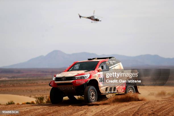 Giniel De Villiers of South Africa and Toyota Gazoo Racing drives with co-driver Dirk Von Zitzewitz of Germany in the Hilux Toyota car in the Classe...