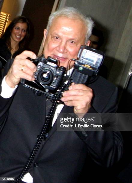 Celebrity photographer Ron Galella poses for photographers during a celebration gala for his book "The Photographs of Ron Galella," March 20, 2002 in...