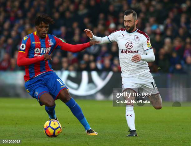 Crystal Palace's Wilfried Zaha under pressure from Burnley's Steven Defour during Premier League match between Crystal Palace and Burnley at Selhurst...