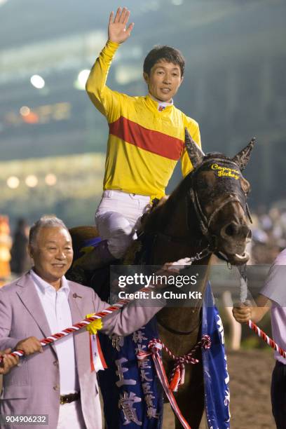 Jockey Yutaka Take and owner Sachiaki Kobayashi celebrate after Copano Rickey winning the Teio Sho at Ohi Racecourse in Tokyo, Japan on June 29,...