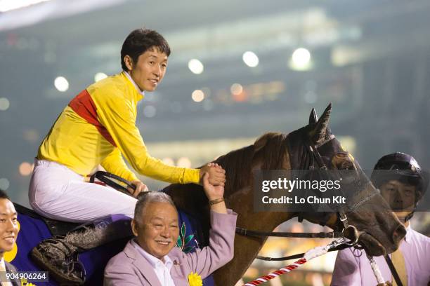 Jockey Yutaka Take and owner Sachiaki Kobayashi celebrate after Copano Rickey winning the Teio Sho at Ohi Racecourse in Tokyo, Japan on June 29,...