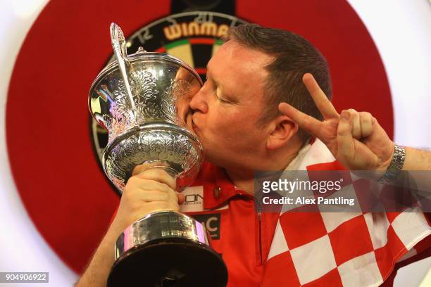 Glen Durrant of England celebrates victory as he kisses the trophy following the final of the BDO World Darts Championship against Mark McGeeney of...