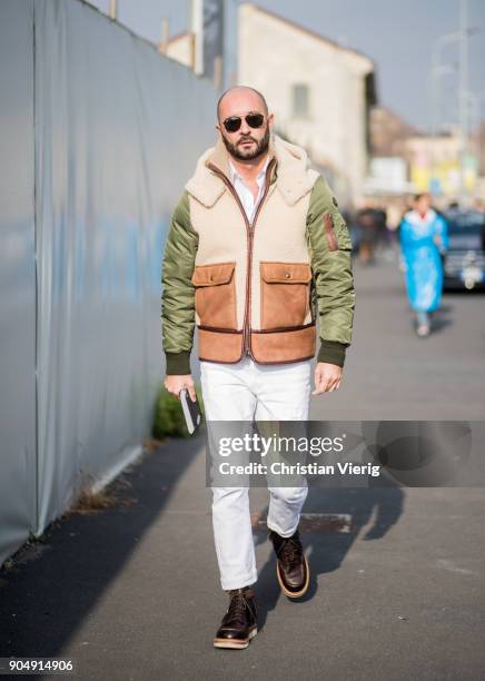 Milan Vukmirovic wearing white pants, bomber jacket is seen outside DSquared2 during Milan Men's Fashion Week Fall/Winter 2018/19 on January 14, 2018...