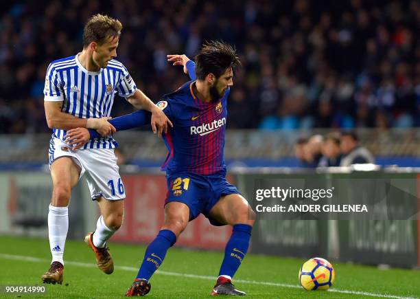 Barcelona's Portuguese midfielder Andre Gomes vies with Real Sociedad's Spanish midfielder Sergio Canales during the Spanish league football match...