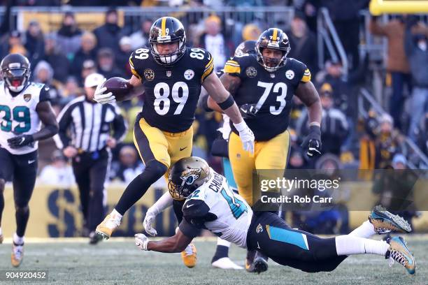 Vance McDonald of the Pittsburgh Steelers jumps over Barry Church of the Jacksonville Jaguars during the second half of the AFC Divisional Playoff...