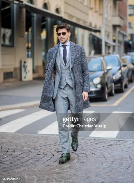 Johannes Huebl wearing grey suit, grey coat is seen outside Daks during Milan Men's Fashion Week Fall/Winter 2018/19 on January 14, 2018 in Milan,...