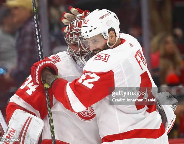 Martin Frk of the Detroit Red Wings hugs Petr Mrazek after shoutout win against the Chicago Blackhawks at the United Center on January 14, 2018 in...