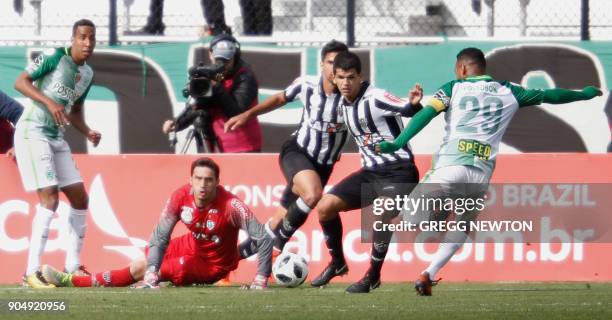 After blocking one kick, goal keeper Cleiton of Brazilian club Atletico Mineiro looks on as Aldo Leao Ramirez of Colombian side Atletico Nacional...