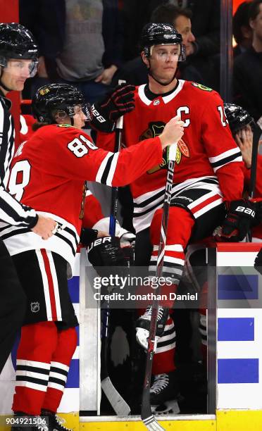 Patrick Kane and Jonathan Toews of the Chicago Blackhawks rest during a break against the Detroit Red Wings at the United Center on January 14, 2018...