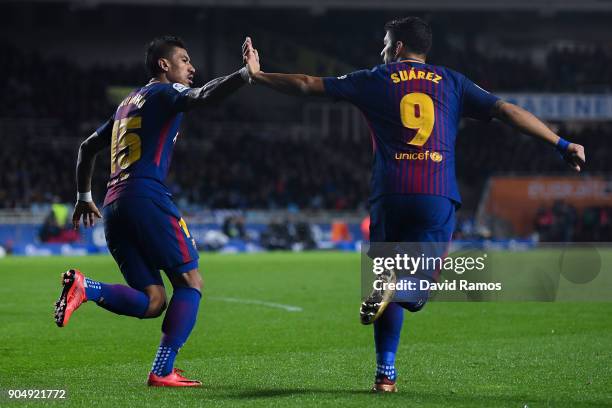 Paulinho Bezerra of FC Barcelona celebrates with his team mate Luis Suarez after scoring his team's first goal during the La Liga match between Real...