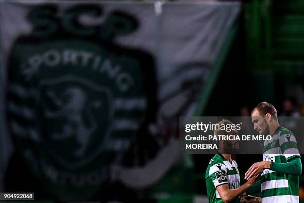 Sporting's Dutch forward Bas Dost greets Sorting's new midfielder Ruben Ribeiro before the Portuguese league football match between Sporting CP and...