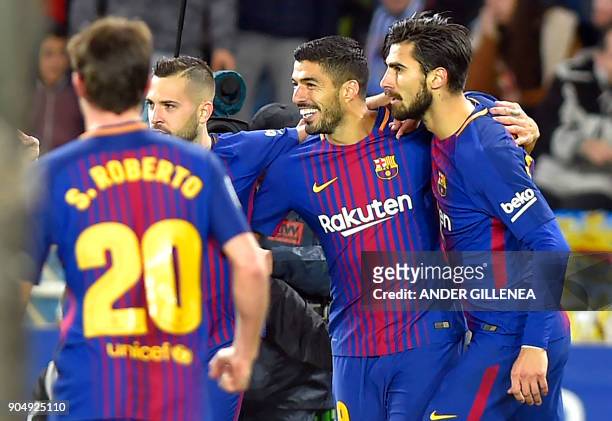 Barcelona's Uruguayan forward Luis Suarez celebrates a goal with Barcelona's Portuguese midfielder Andre Gomes and Barcelona's Spanish defender Jordi...