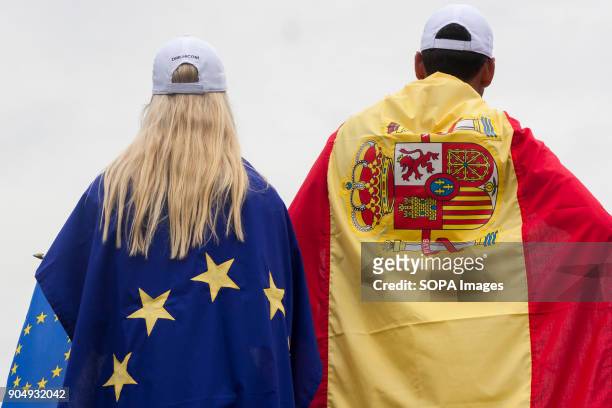 Rafa Cabrera Bello is seen with Spain flag while a lady with a Europe Flag on the last day at EurAsia Cup 2018. EurAsia Cup is a biennial men...