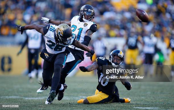 Martavis Bryant of the Pittsburgh Steelers cannot come up with a catch while being defended by Jarrod Wilson of the Jacksonville Jaguars and A.J....